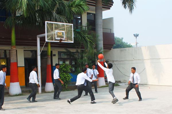 Students playing basketball on campus